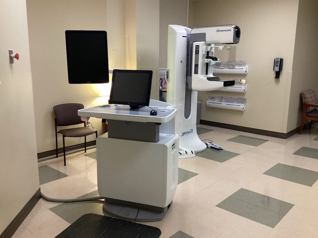 Hologic 3Dimensions 3D mammography system and acquisition workstation installed in a clinic exam room.